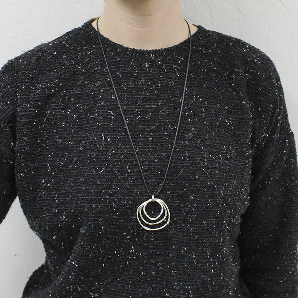 Medium Tiered Hammered Rings on Black Cord Necklace