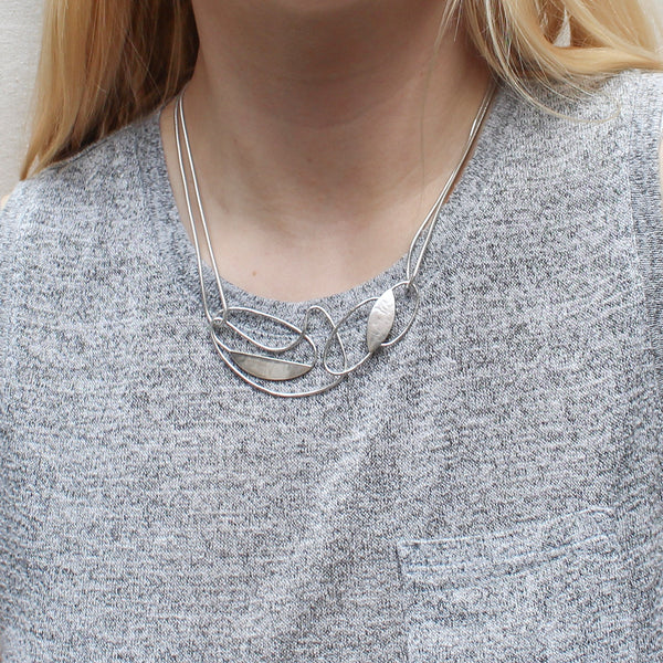 Oval Rings with Leaf and Slice and Swoosh Ring Necklace